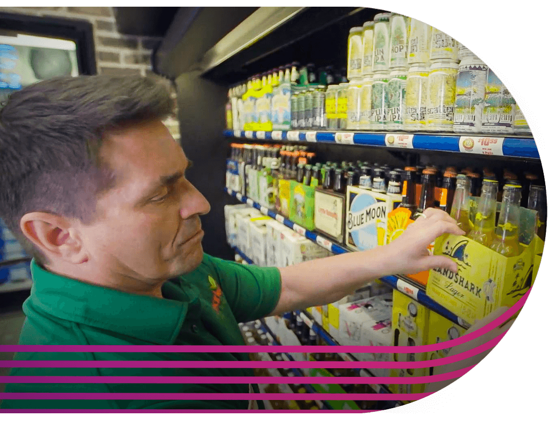 Employee stocking beverage at shelf