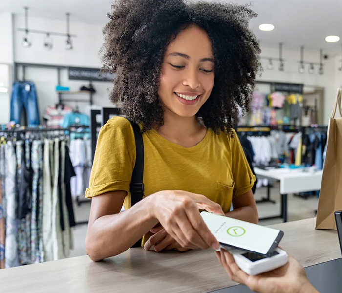 women tapping phone for purchase