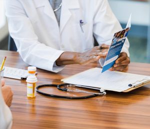 doctor holding brochure
