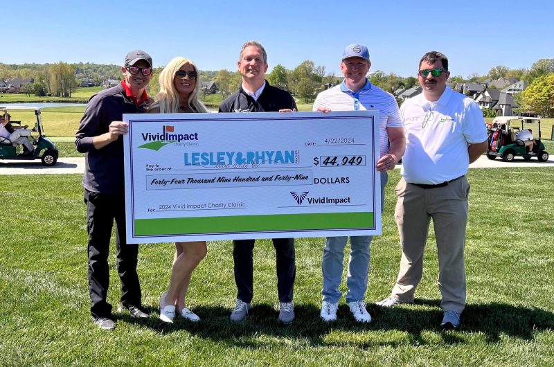 Team at Charity Classic with check